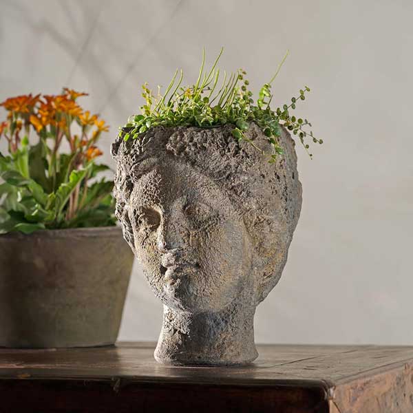 Claudia Planter on table filled with plants