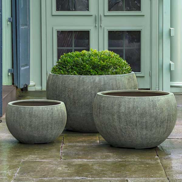 Wakefield Planter, Large - Verdigris Lite on concrete filled with plants