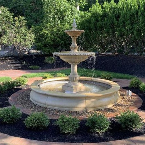 Charleston Fountain in basin on mixed pebbles in backyard