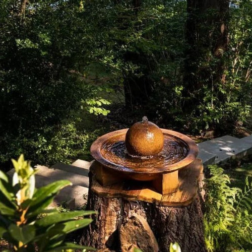 Low Zen Sphere fountain on tree stump near lake featured image