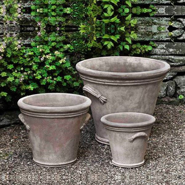 Antico Terra Cotta Planter collection image of fluted handle planter on gravel in the backyard