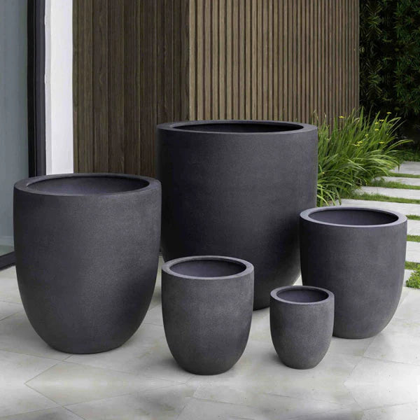 Commercial Planters Collection Image of Bradford, Extra Large Planter in charcoal premium lite S/1on patio near green plants.