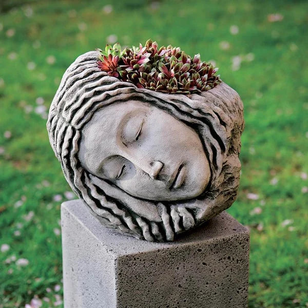 Face Planters Collection Image of Sleeping Maiden Planter filled with plants in the backyard.