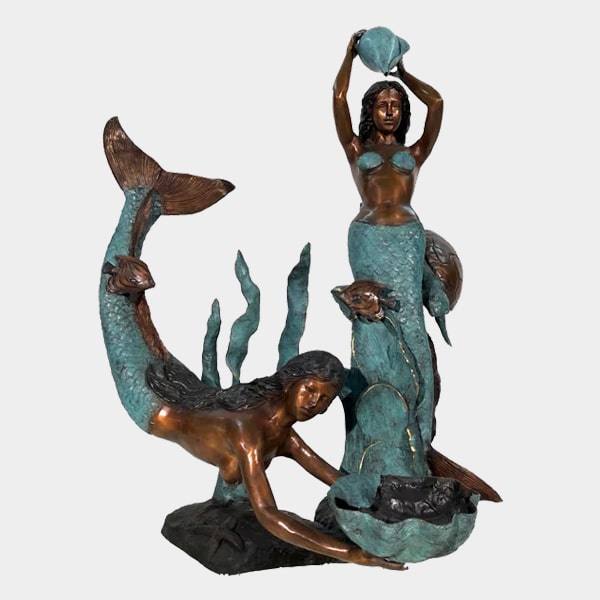 Bronze Mermaids in sea fountain sculpture in action against white backdrop