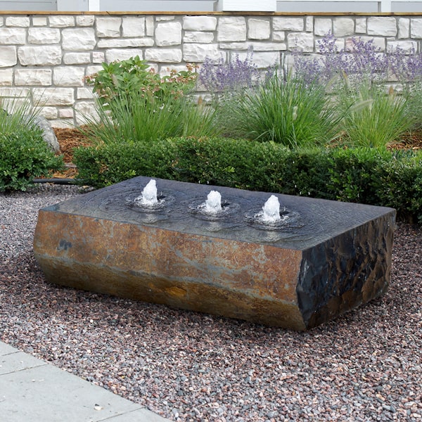 Rock Fountains Collection Image of Triple Drilled Ichise on gravel in the backyard.