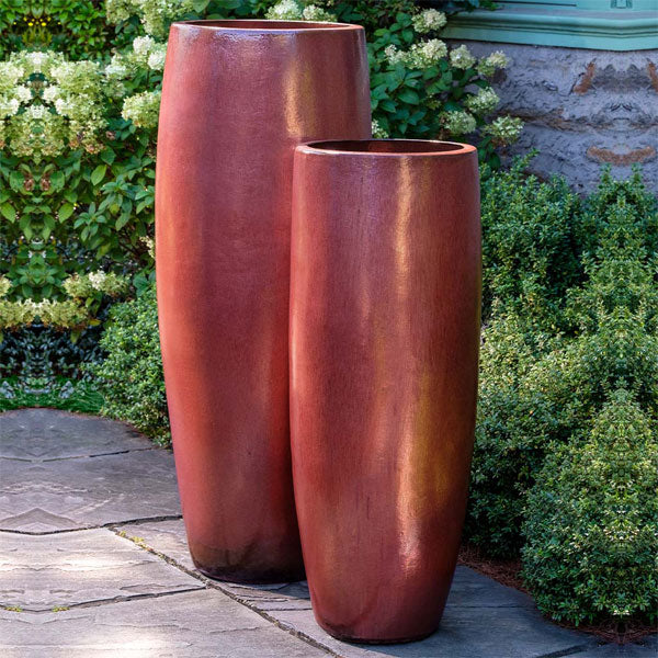 Tall Planters Collection Image of Sabine Planter, Tall - Maple Red - S/1 beside plants.