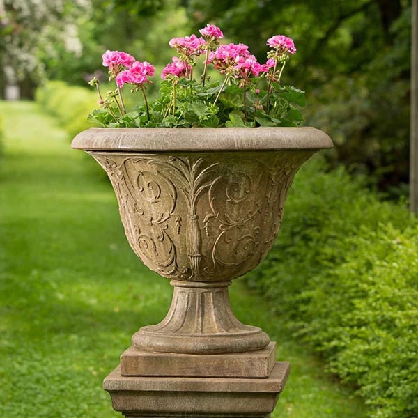 Urn Planters Collection Image of Palais Arabesque Urn filled with pink flowers in the backyard.