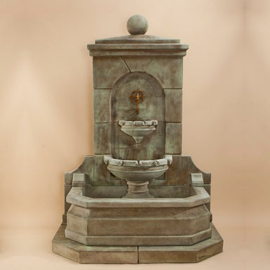 Acquitaine Wall Fountain against brown background.
