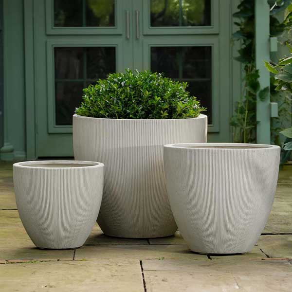 Airy Planter, Large - Alabaster Lite on concrete filled with plants