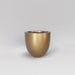 Alzira Round Fiberglass Planter in gloss metallic gold against gray background.