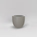 Alzira Round Fiberglass Planter in matte cement grey against gray background.