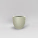 Alzira Round Fiberglass Planter in satin beige against gray background.