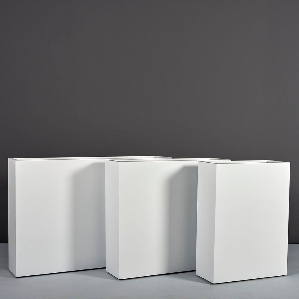 Amesbury Narrow Rectangle Planter on concrete shown in different sizes.