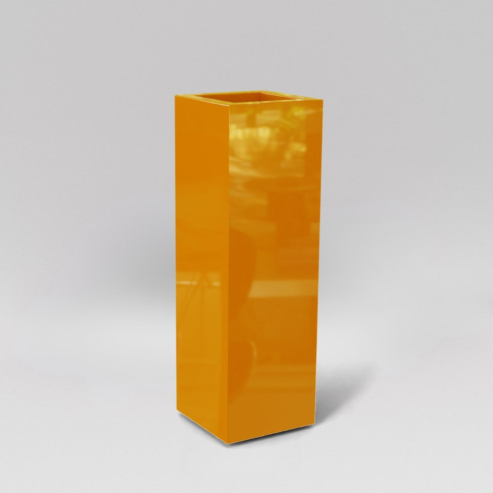 Amesbury Tall Corner Planter in gloss tangerine against gray background.