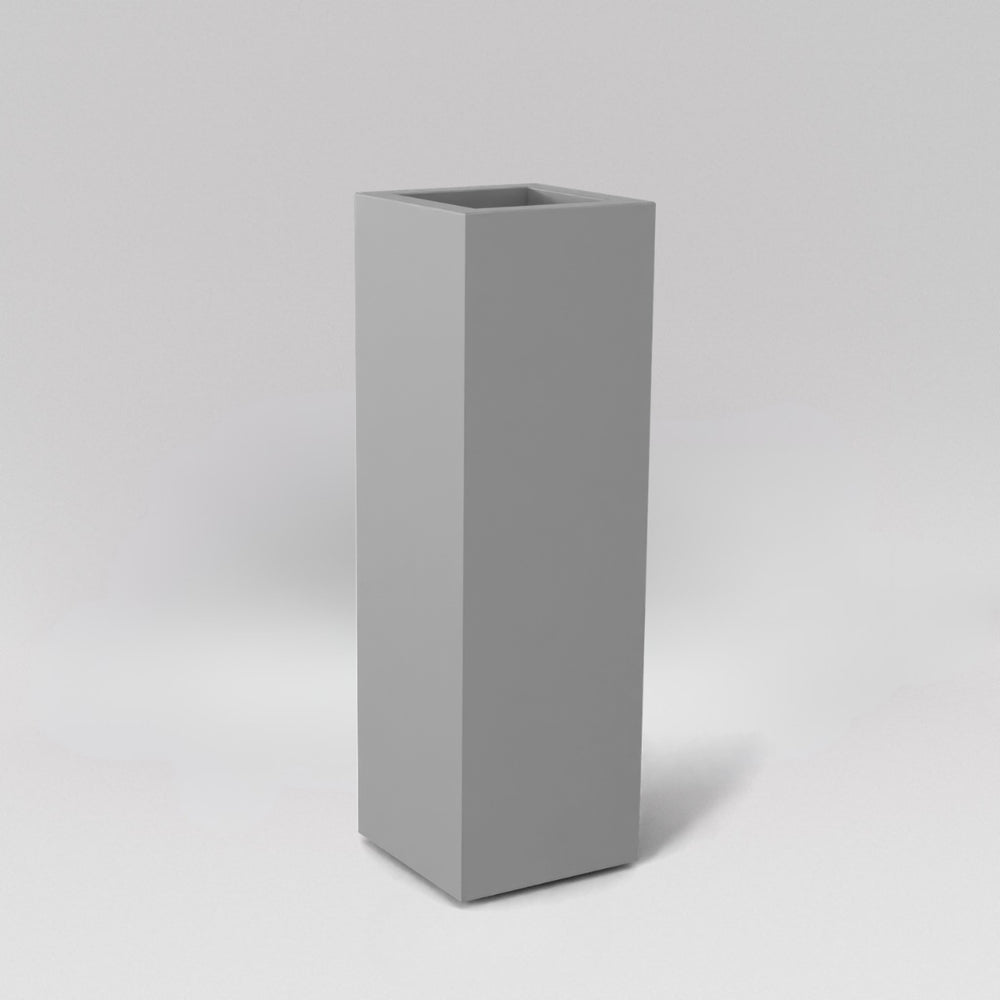 Amesbury Tall Corner Planter in matte cement grey against gray background.