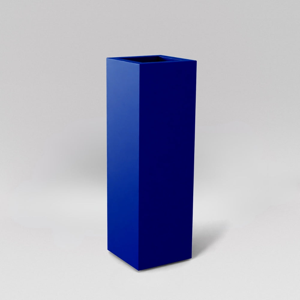 Amesbury Tall Corner Planter in matte cobalt blue against gray background.