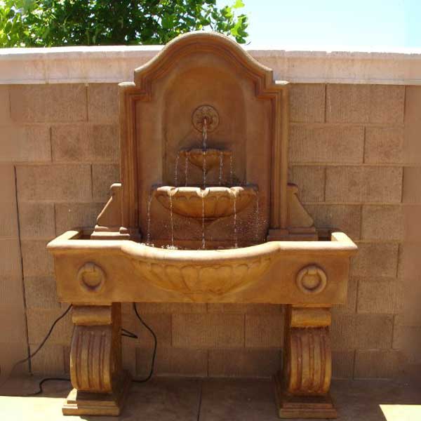 Anduze Wall Fountain, Tall in action on concrete wall.