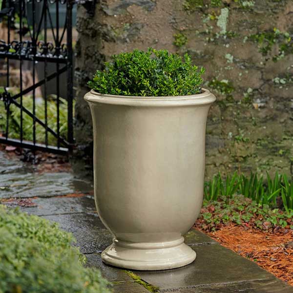 Antibe Urn - Cream - S/1 on concrete filled with plants