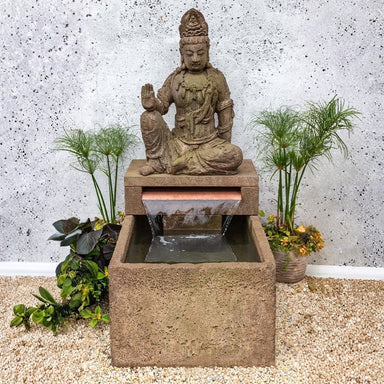 Antique Quan Yin Fountain on gravel in the backyard