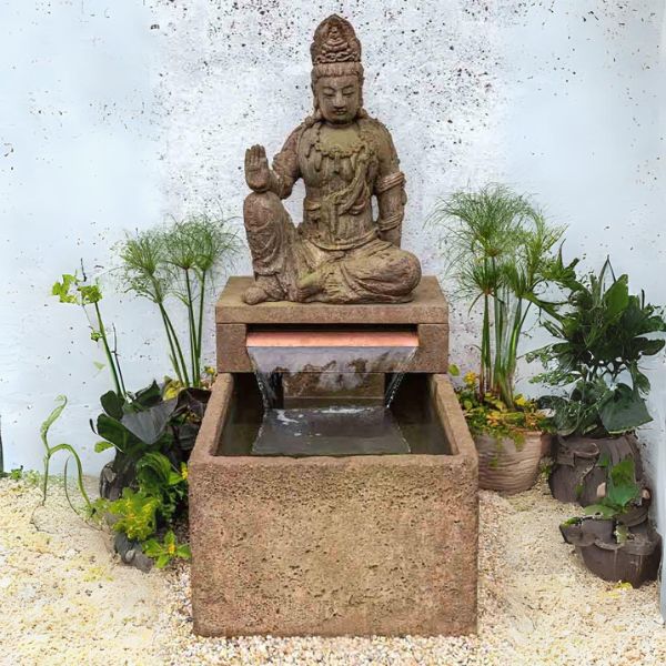 Antique Quan Yin Fountain on gravel in the backyard