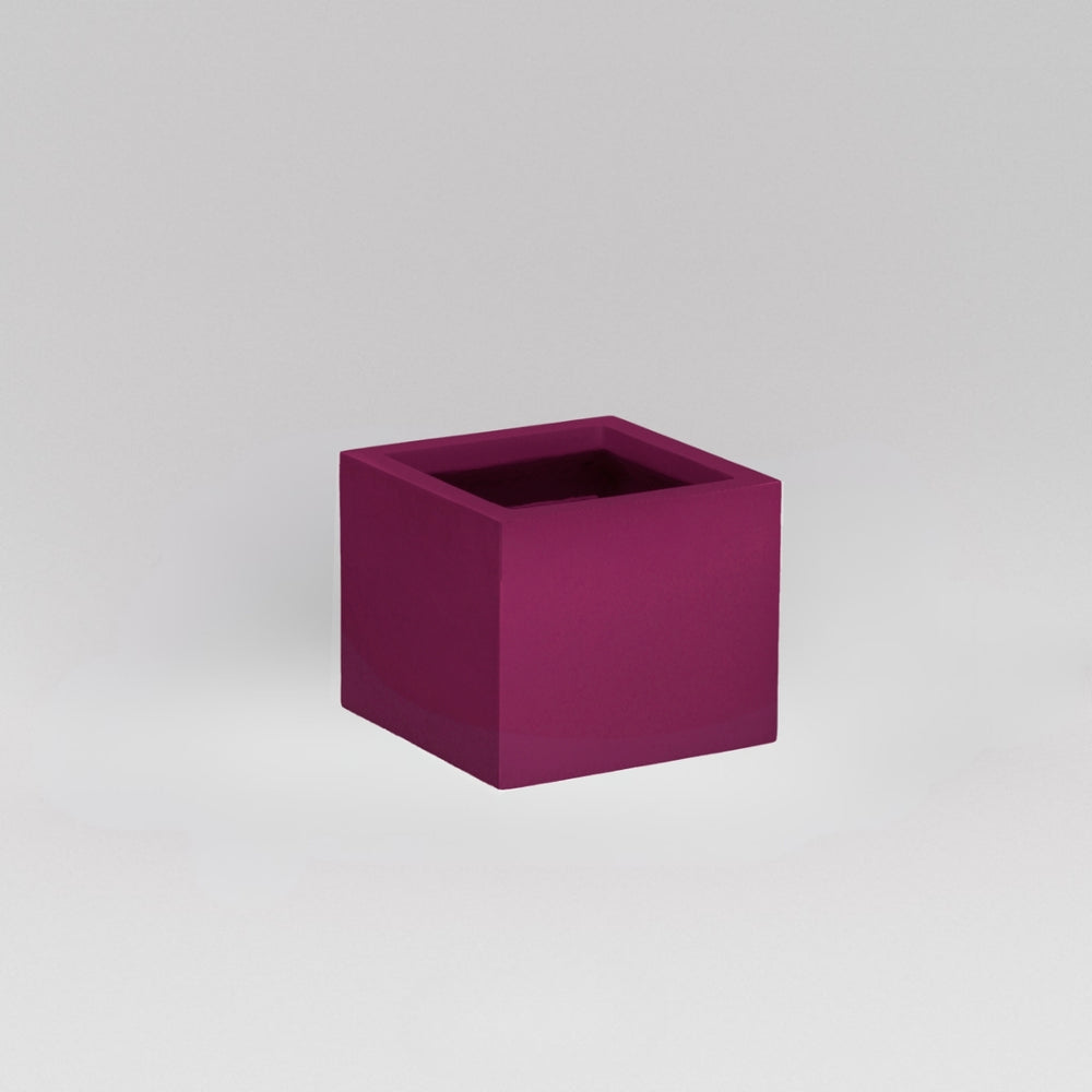 Antwerp Corner Fiberglass Planter in gloss eggplant against gray background.