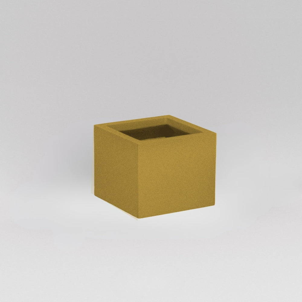 Antwerp Corner Fiberglass Planter in gloss metallic gold against gray background.