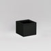 Antwerp Corner Fiberglass Planter in matte black against gray background.