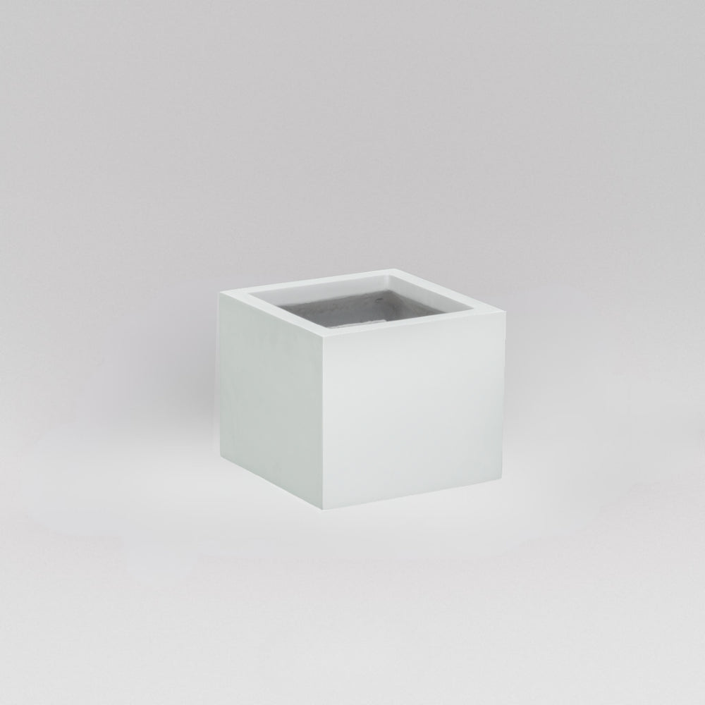 Antwerp Corner Fiberglass Planter in matte bright white against gray background.