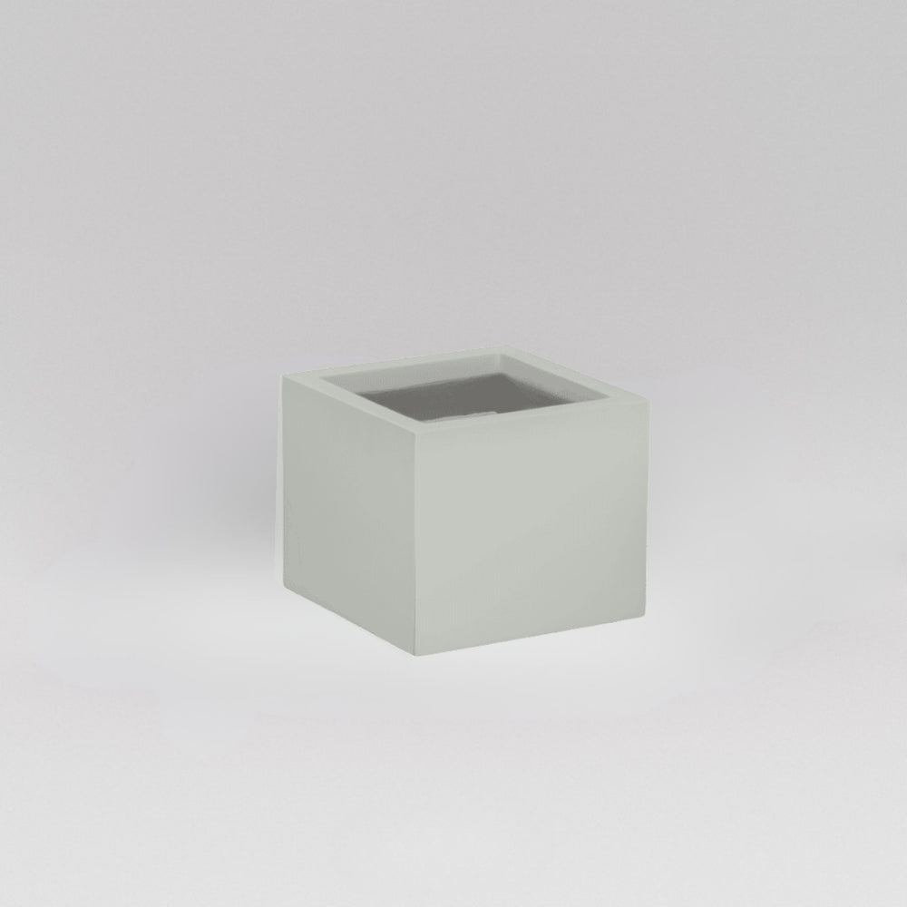Antwerp Corner Fiberglass Planter in matte cement grey against gray background.