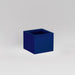 Antwerp Corner Fiberglass Planter in matte cobalt blue against gray background.