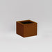 Antwerp Corner Fiberglass Planter in metallic bronze against gray background.