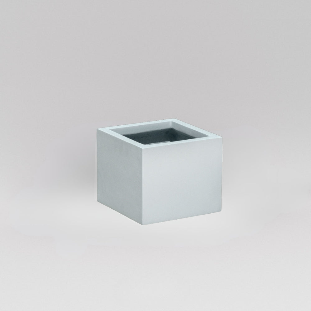 Antwerp Corner Fiberglass Planter in metallic silver against gray background.