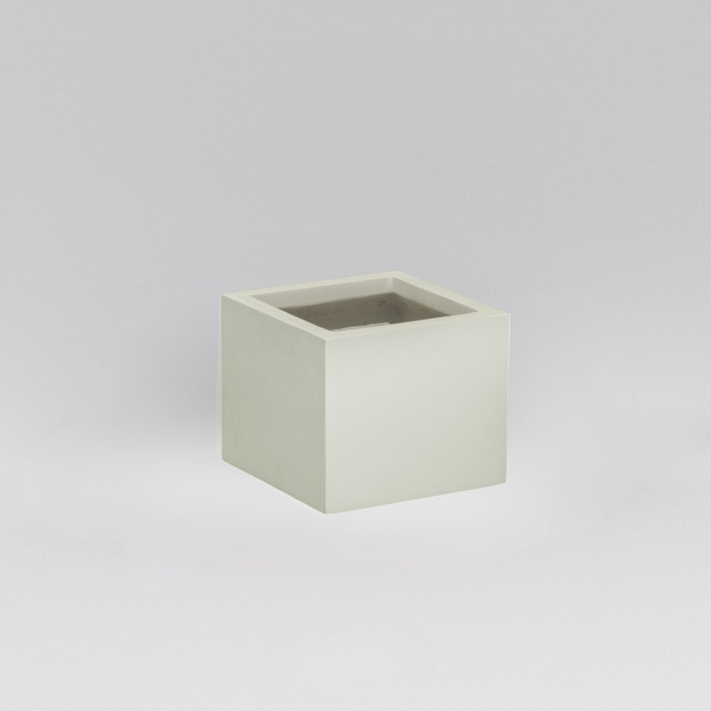 Antwerp Corner Fiberglass Planter in satin beige against gray background.