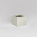 Antwerp Corner Fiberglass Planter in satin beige against gray background.
