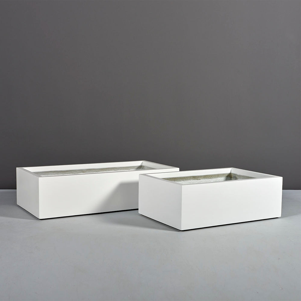 Antwerp Wide Rectangular Fiberglass Planter on concrete shown in different sizes.