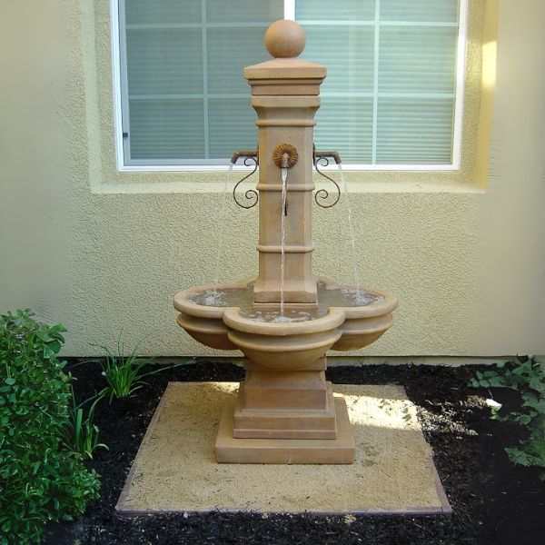 Avignon Courtyard Fountain in action against house window.