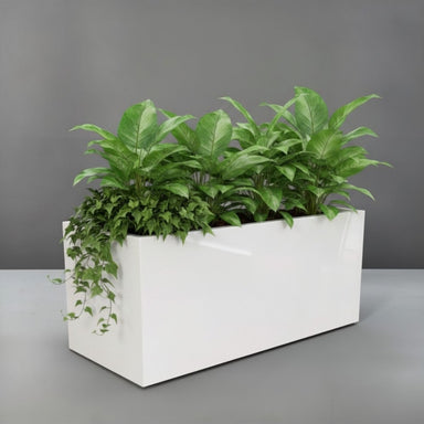 Badalona Rectangle Fiberglass  Planter filled with plants against gray backdrop
