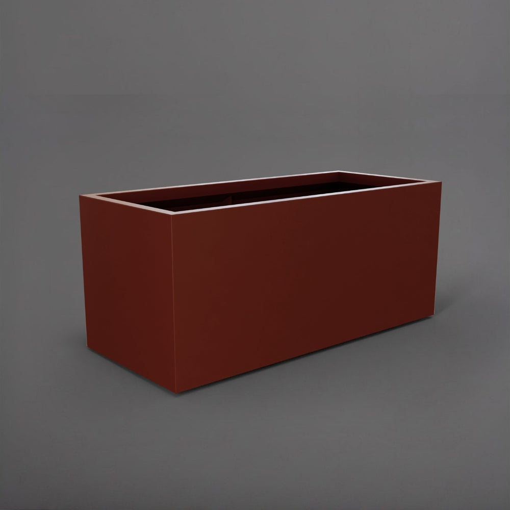 Badalona Rectangle Fiberglass Planter in matte terra cotta against gray background.