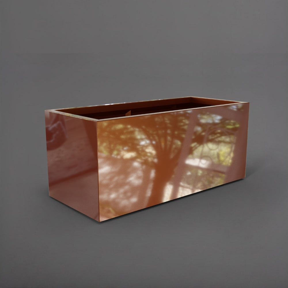 Badalona Rectangle Fiberglass Planter in metallic bronze against gray background.