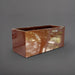 Badalona Rectangle Fiberglass Planter in metallic bronze against gray background.