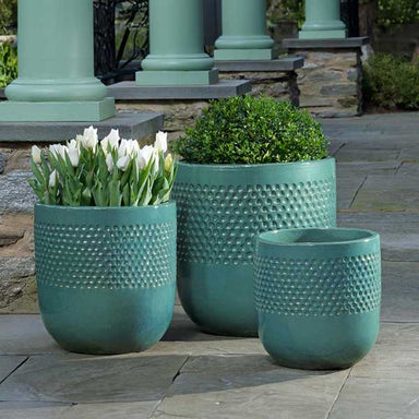 Banded Coin Pot Planter - Glacier Green - S/3 on concrete filled with plants