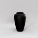 Bara Jar Tall Tapered Fiberglass Planter in matte black against gray background.