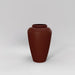 Bara Jar Tall Tapered Fiberglass Planter in matte terra cotta against gray background.