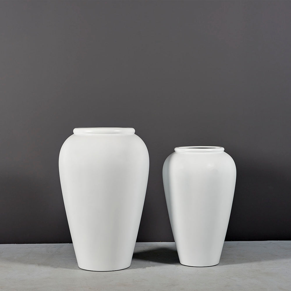 Bara Jar Tall Tapered Fiberglass Planter on concrete shown with different sizes.