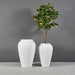 Bara Jar Tall Tapered Fiberglass Planter shown with different sizes filled with plants.