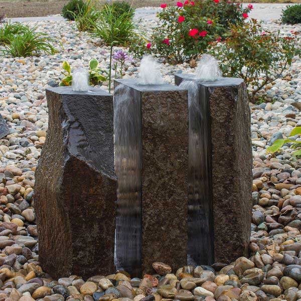 Basalt Fountain Kit 24 Triple Split polished 3 piece on mixed pebbles in the backyard