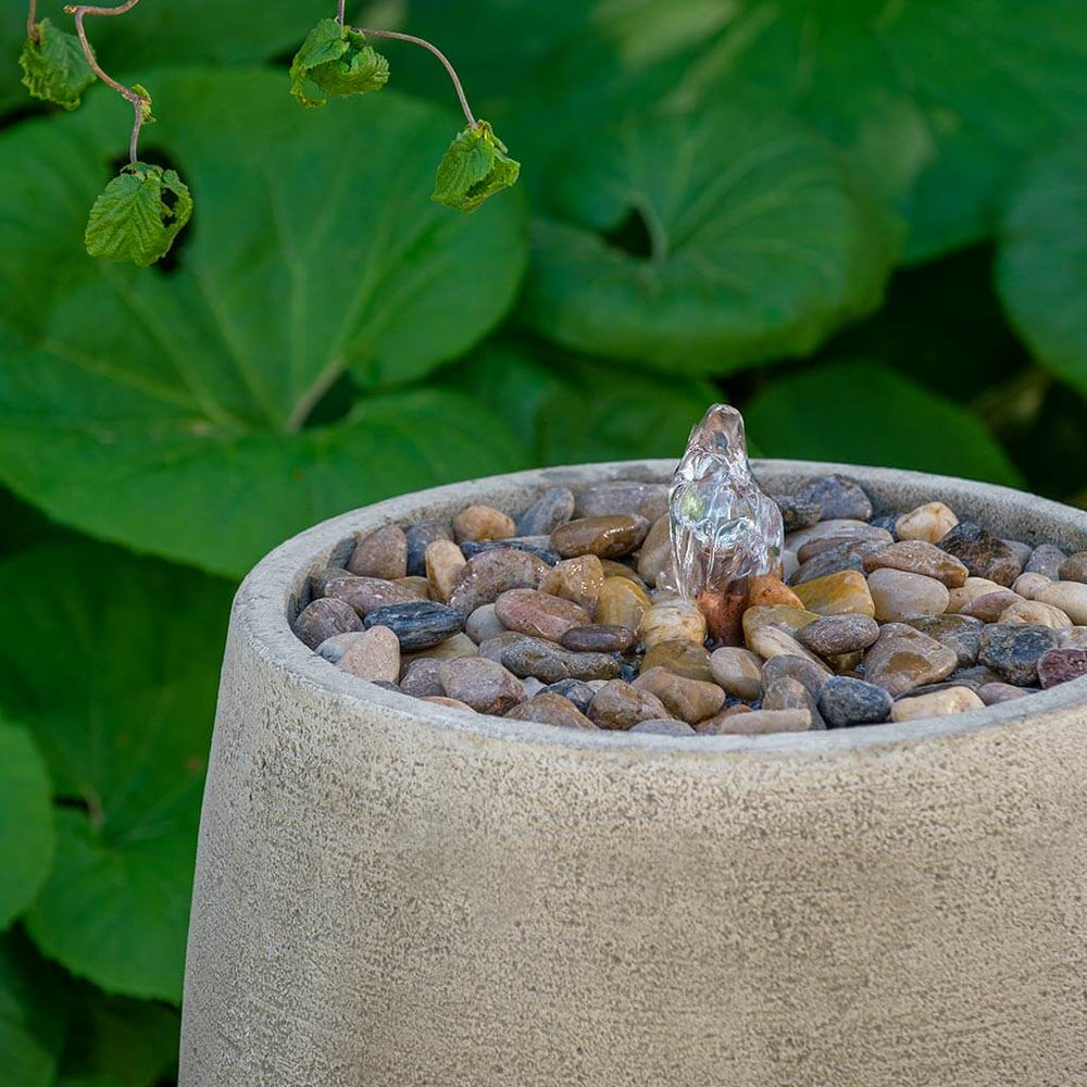 Bebel Pebble Fountain, Tall on gravel in the backyard upclose.