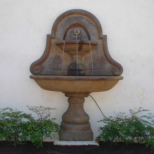 Belair Wall Fountain for spout in action against cream wall.