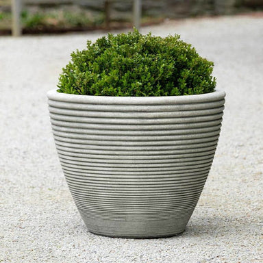 Bibendum Planter, Medium on gravel filled with plants.
