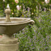 Borghese Bubble Fountain Outdoor in action near purple flowers upclose.